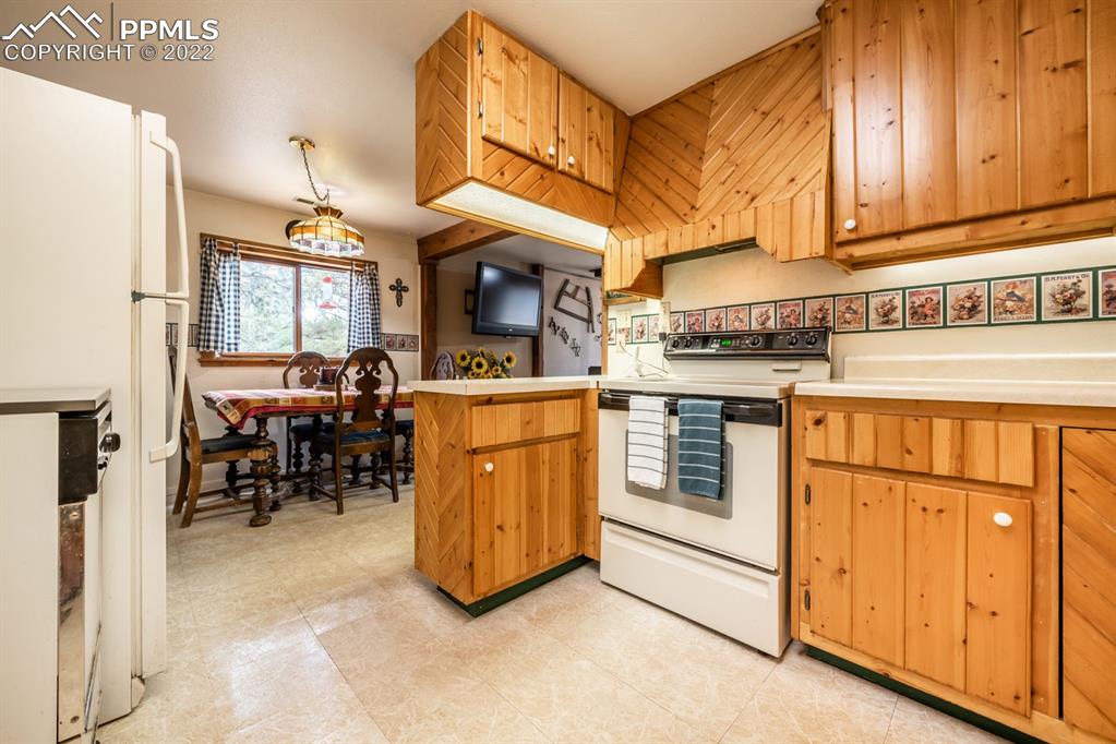 8181 Maple Drive Rye, CO 81069 - Photo 10 of 50 a kitchen with stainless steel appliances granite countertop a stove and a refrigerator