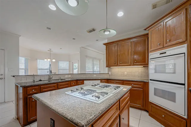 a kitchen with a stove and a refrigerator