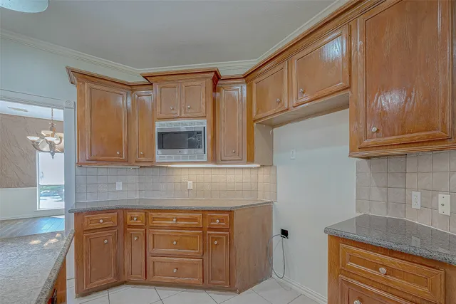 a kitchen with granite countertop cabinets stainless steel appliances and a counter space