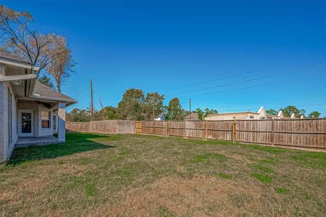 a big house with a big yard and large trees