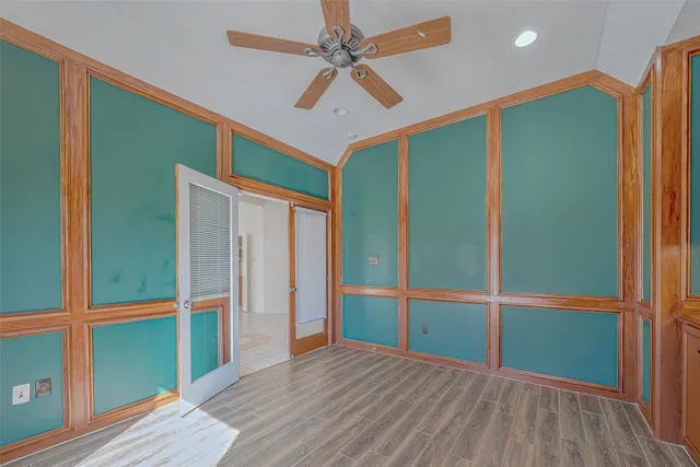 a view of empty room with wooden floor