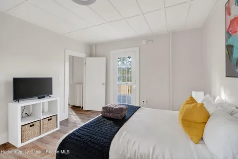 a bedroom with a bed and a flat screen tv