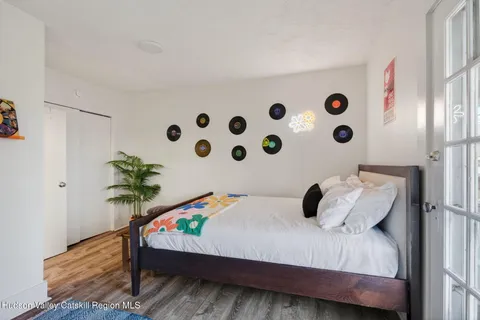 a bedroom with a bed and a potted plant