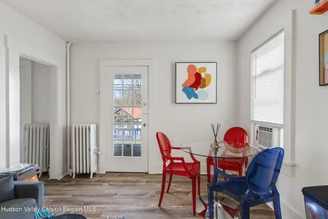 a dining room with furniture and wooden floor