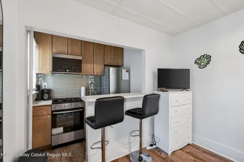 a kitchen with stainless steel appliances a stove a sink and a microwave