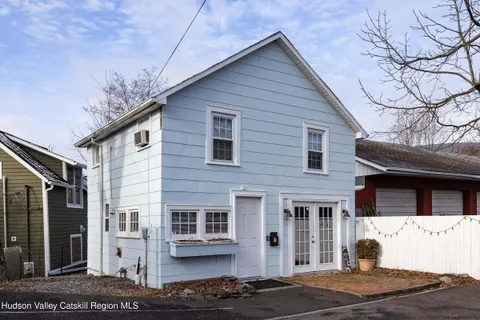 a view of a house with a tree