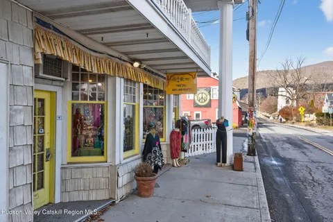 a view of path along with retail shop and outdoor seating