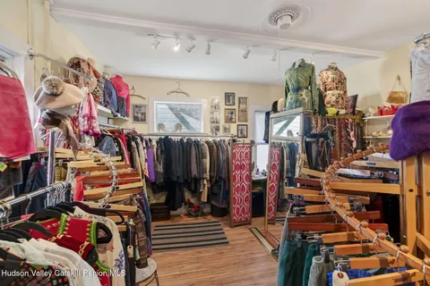 a view of walk in closet with clothes