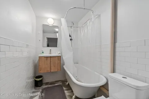 a bathroom with a toilet a sink and bathtub