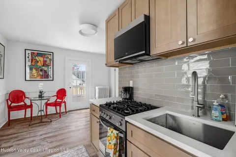 a kitchen with stainless steel appliances kitchen island granite countertop a sink and a microwave