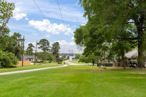 a view of a fountain in front of a house with a big yard