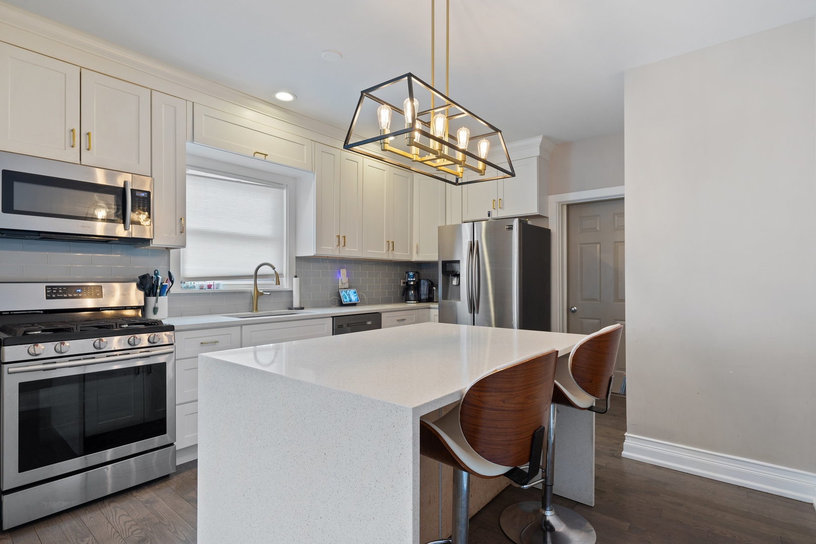 3336 Grand Boulevard Brookfield, IL 60513 - Photo 6 of 35 a kitchen with stainless steel appliances a stove a sink cabinets and a refrigerator