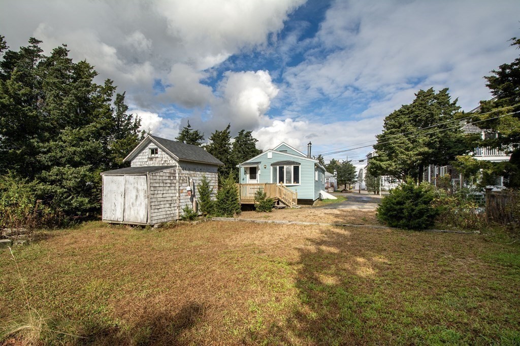 37 Pine Point Road Duxbury, MA 02332 - Photo 21 of 24 a front view of a house with a yard and garage