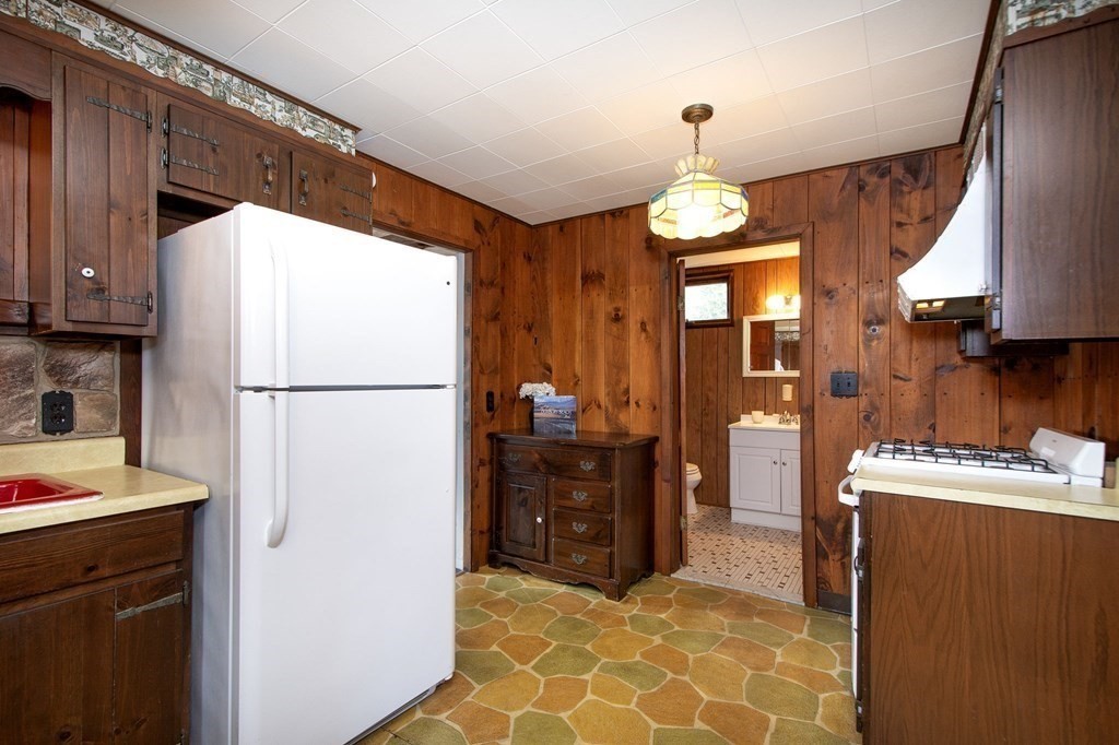 37 Pine Point Road Duxbury, MA 02332 - Photo 10 of 24 a kitchen view with granite countertop a refrigerator a stove and a sink
