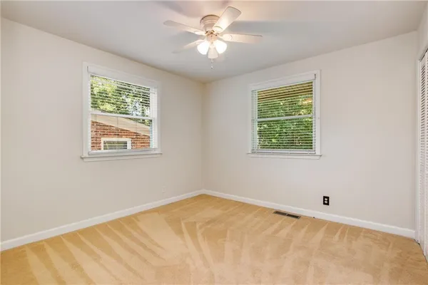 a view of a room with a window and a ceiling fan