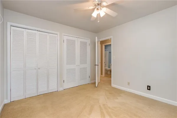 an empty room with a chandelier fan