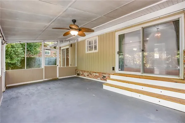 a view of an empty room with a floor to ceiling window and carpet