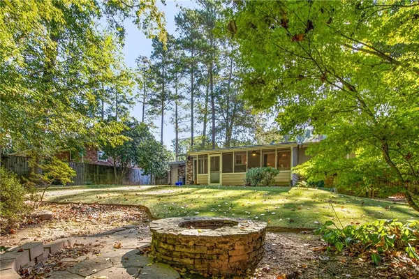 a view of a house with swimming pool and a yard
