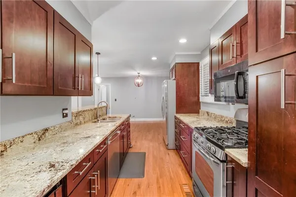 a kitchen with a sink stove and refrigerator