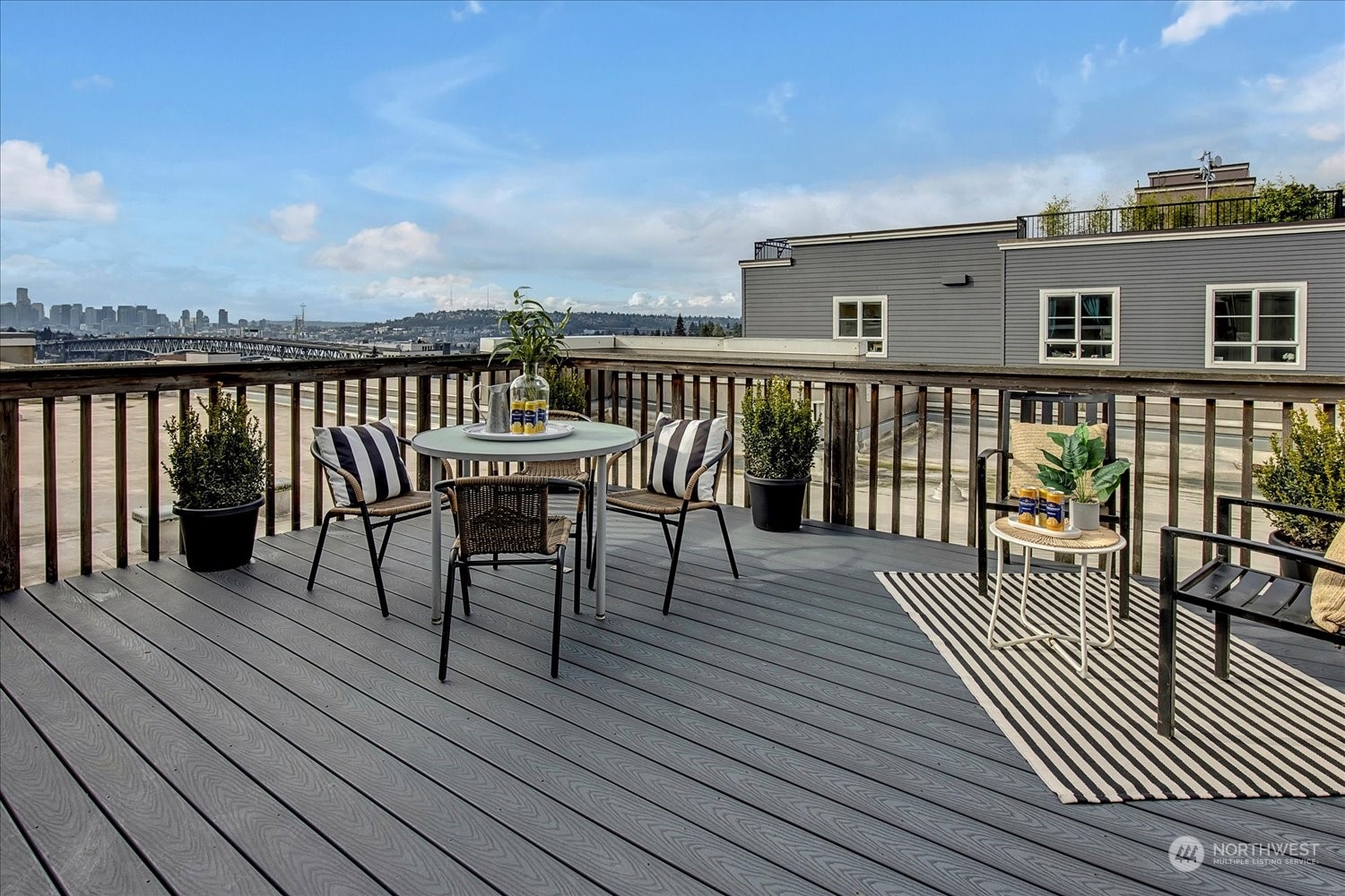 a view of a roof deck with table and chairs