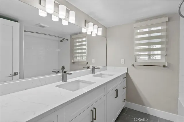 a bathroom with a sink a vanity and a mirror