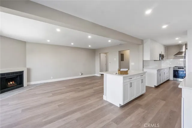 a kitchen with stainless steel appliances granite countertop a stove top oven and sink