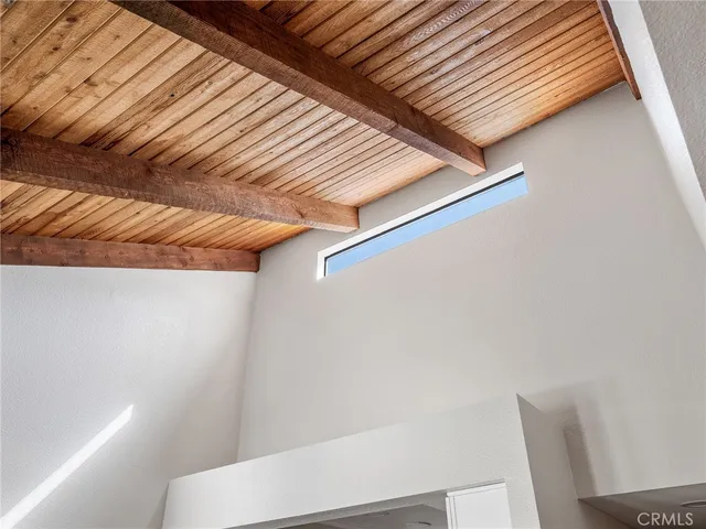 a view of a porch with wooden floor and roof