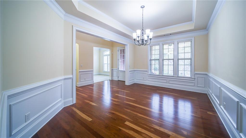 2220 Stirling Bridge Road Cumming, GA 30041 - Photo 13 of 82 a view of an empty room with wooden floor and a window