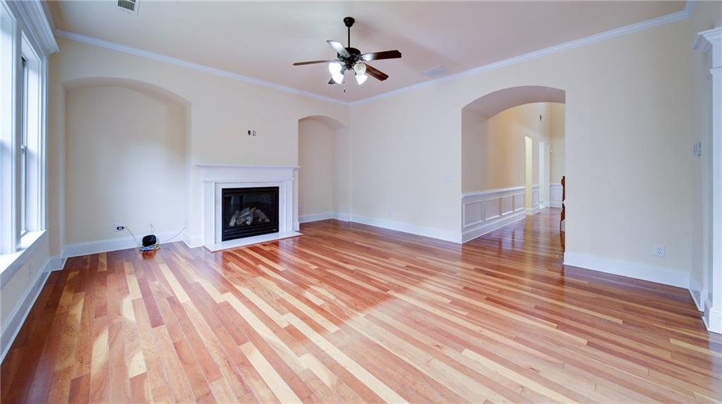 2220 Stirling Bridge Road Cumming, GA 30041 - Photo 17 of 82 a view of empty room with wooden floor and fireplace