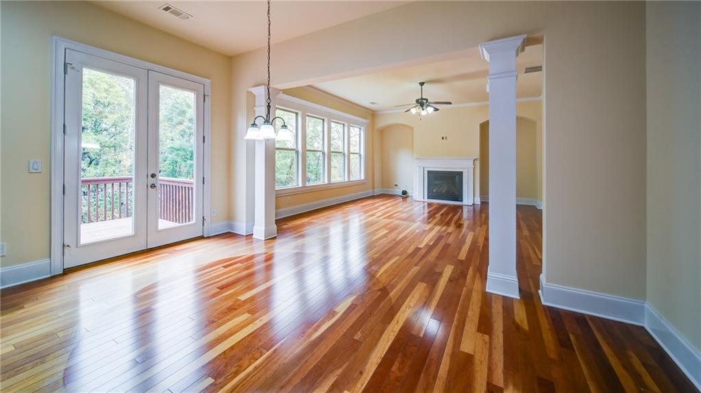 2220 Stirling Bridge Road Cumming, GA 30041 - Photo 20 of 82 a view of a living room with wooden floor and fireplace