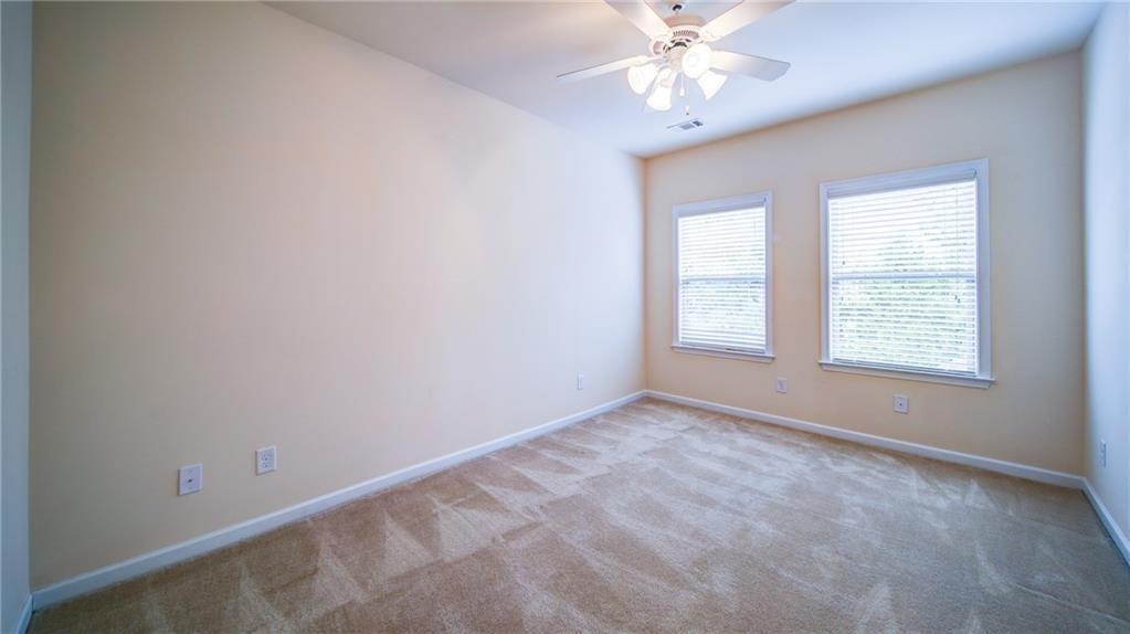 2220 Stirling Bridge Road Cumming, GA 30041 - Photo 45 of 82 an empty room with a window and a fan