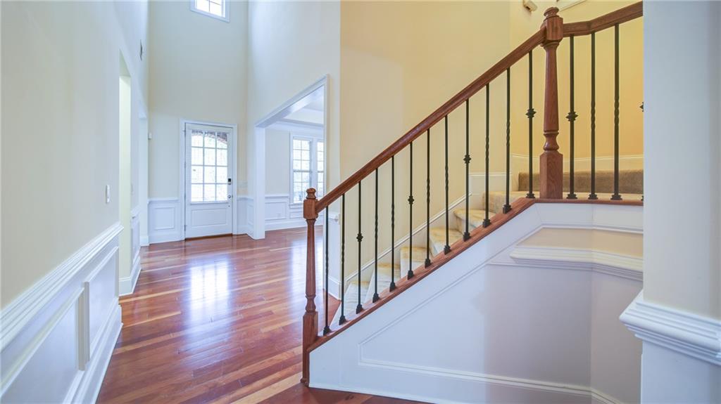 2220 Stirling Bridge Road Cumming, GA 30041 - Photo 5 of 82 a view of a hallway with wooden floor and staircase