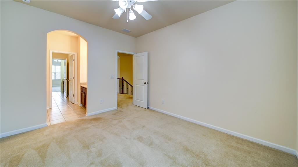2220 Stirling Bridge Road Cumming, GA 30041 - Photo 51 of 82 an empty room with a chandelier fan and a window