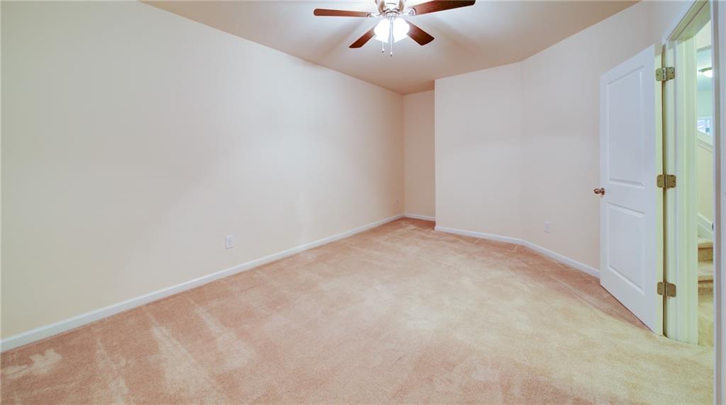 2220 Stirling Bridge Road Cumming, GA 30041 - Photo 57 of 82 an empty room with a window and a ceiling fan