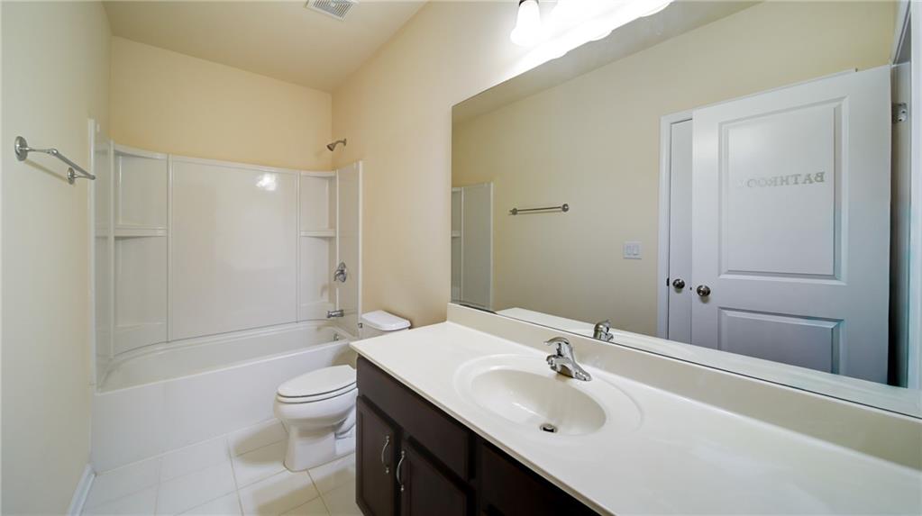 2220 Stirling Bridge Road Cumming, GA 30041 - Photo 58 of 82 a bathroom with a sink toilet and shower
