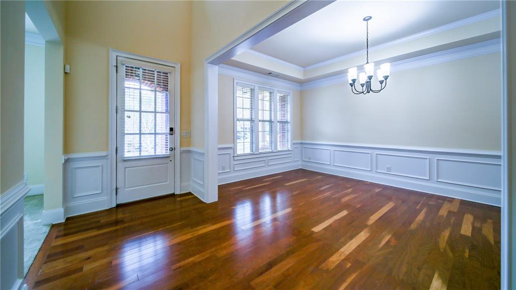 2220 Stirling Bridge Road Cumming, GA 30041 - Photo 6 of 82 a view of empty room with wooden floor and fan