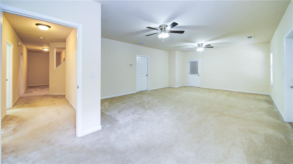 2220 Stirling Bridge Road Cumming, GA 30041 - Photo 61 of 82 a view of an empty room with a chandelier fan