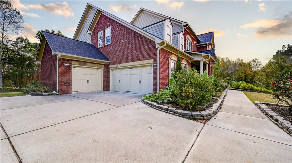 2220 Stirling Bridge Road Cumming, GA 30041 - Photo 71 of 82 a front view of a house with a yard and potted plants