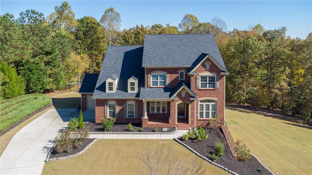 2220 Stirling Bridge Road Cumming, GA 30041 - Photo 79 of 82 front view of house with a yard and potted plants