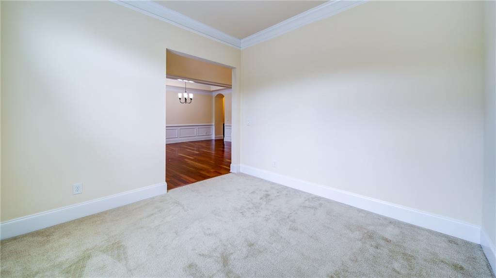 2220 Stirling Bridge Road Cumming, GA 30041 - Photo 9 of 82 a view of an empty room with wooden floor and a window