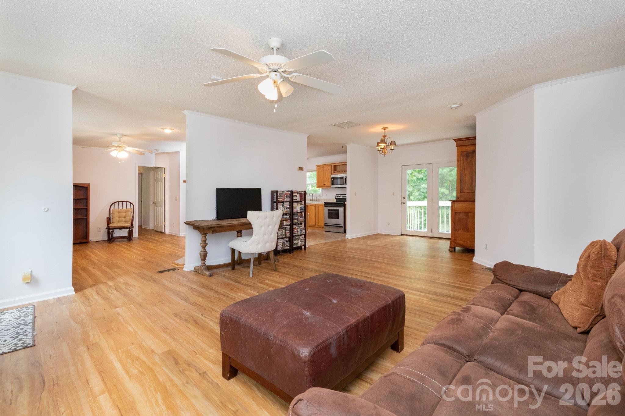 16 Rusty Clay Ridge Fairview, NC 28730 - Photo 11 of 19 a living room with furniture and a chandelier