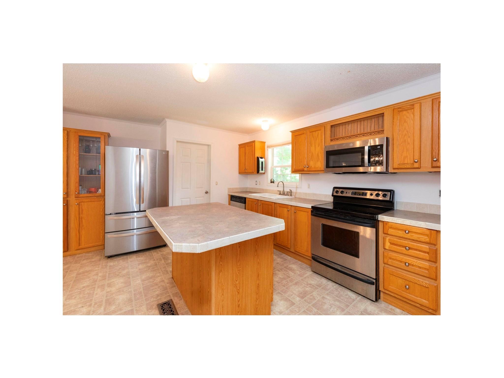 16 Rusty Clay Ridge Fairview, NC 28730 - Photo 14 of 19 a kitchen with stainless steel appliances kitchen island a stove a sink and a refrigerator