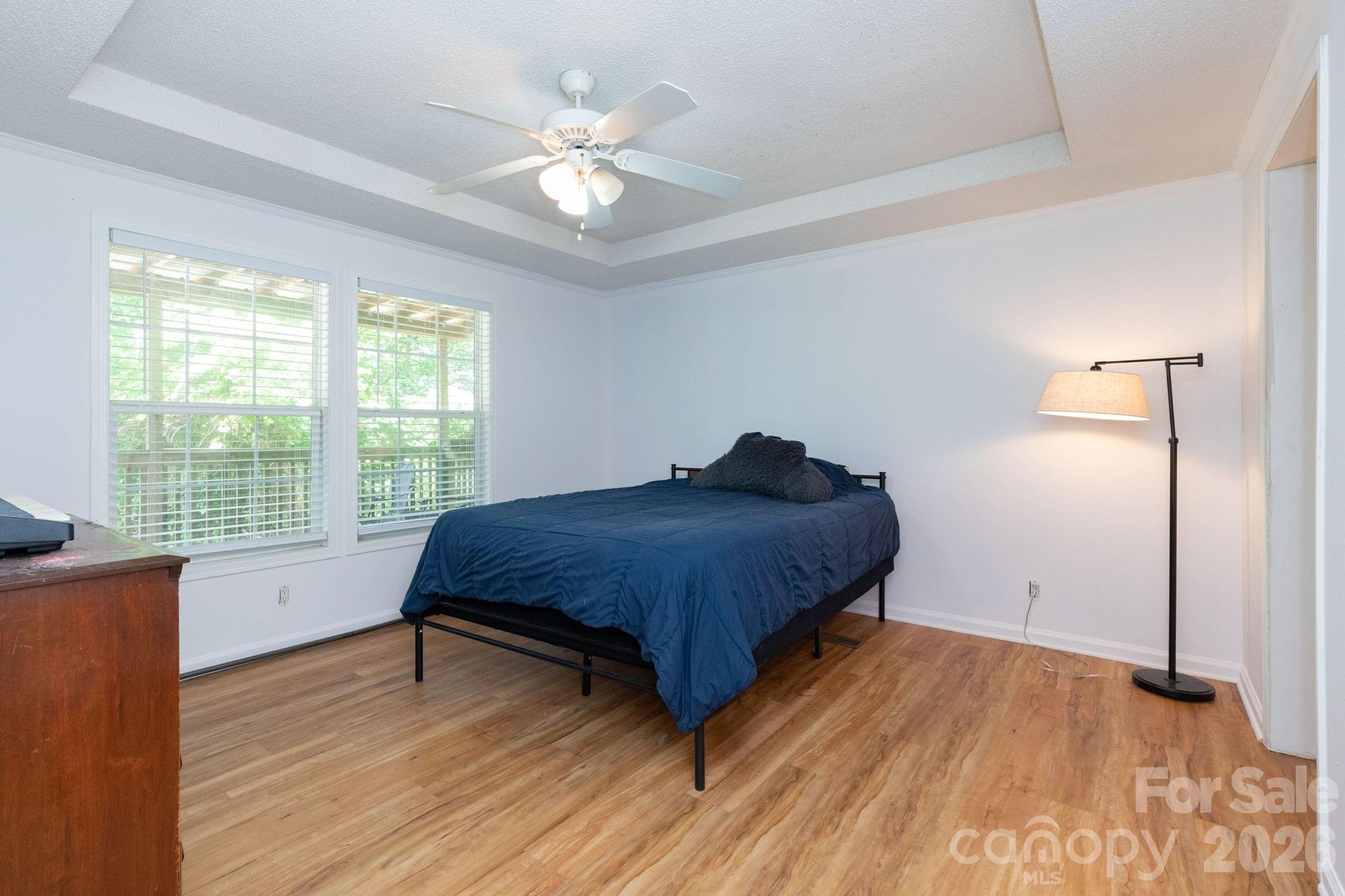 16 Rusty Clay Ridge Fairview, NC 28730 - Photo 17 of 19 a spacious bedroom with a bed and a window