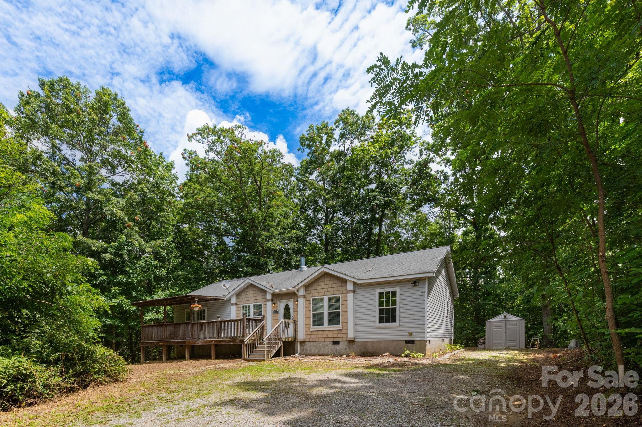 16 Rusty Clay Ridge Fairview, NC 28730 - Photo 2 of 19 a front view of a house with a garden