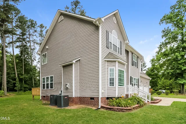 a front view of house with yard and green space