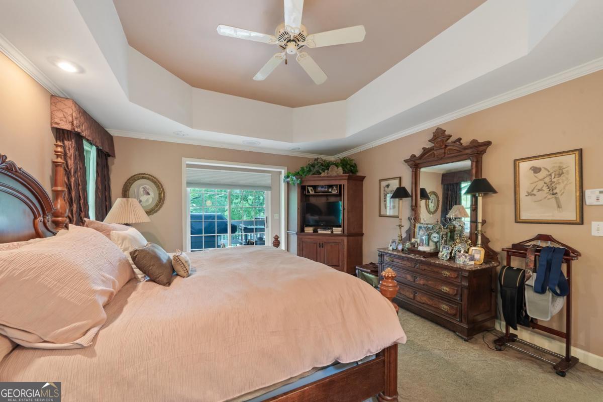 1031 Old Still Road Greensboro, GA 30642 - Photo 33 of 73 a bed sitting in a spacious bedroom next to a window