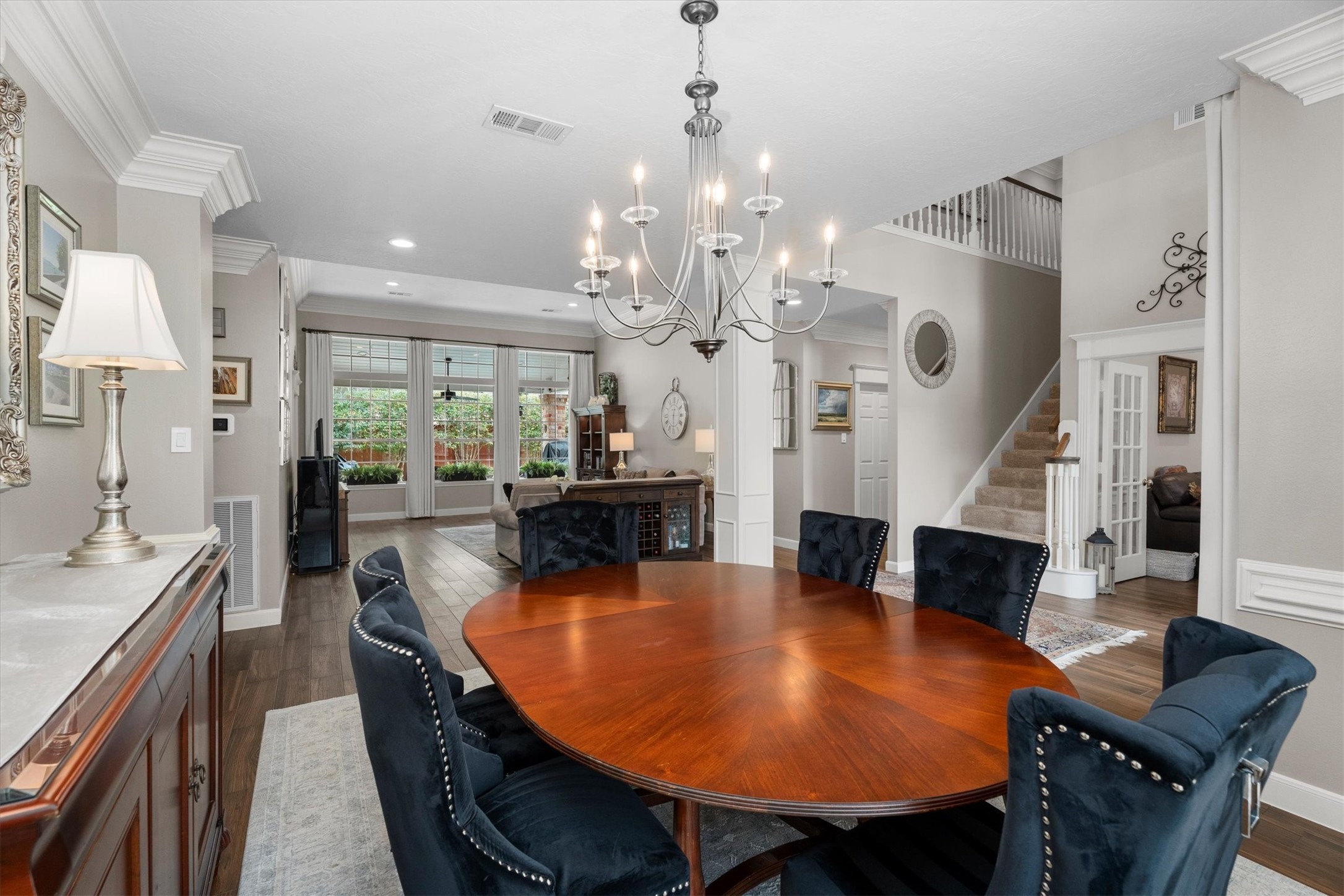 16022 Stewarts Grove Drive Spring, TX 77379 - Photo 13 of 45 a dining room with furniture a chandelier and wooden floor