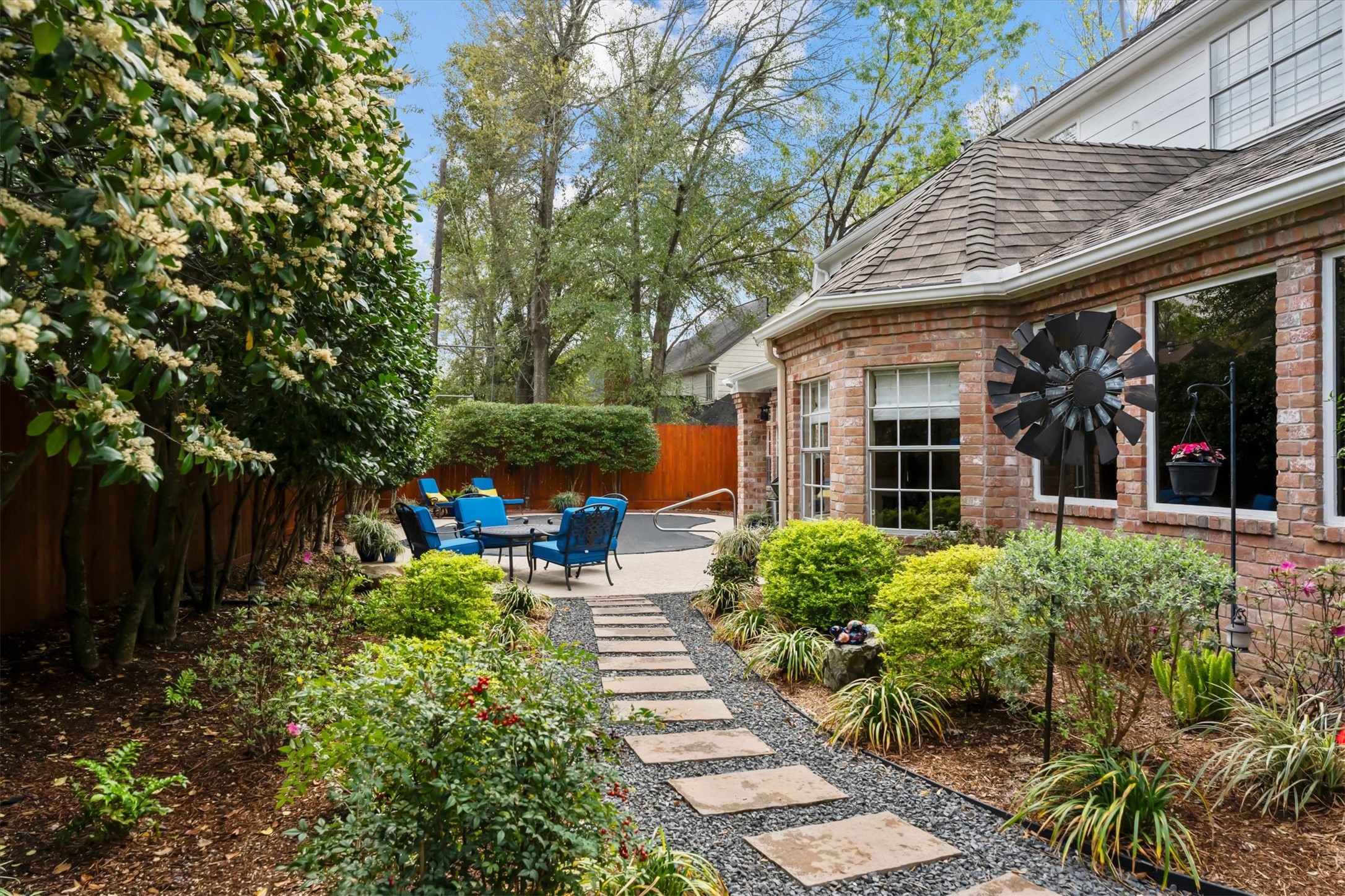 16022 Stewarts Grove Drive Spring, TX 77379 - Photo 41 of 45 BACKYARD GARDEN & PATHWAY: In 2024, the backyard underwent a comprehensive remodel. This included the installation of additional garden drains and professional landscaping. The landscaping features Texas native plants and a crushed granite walkway with pavers.