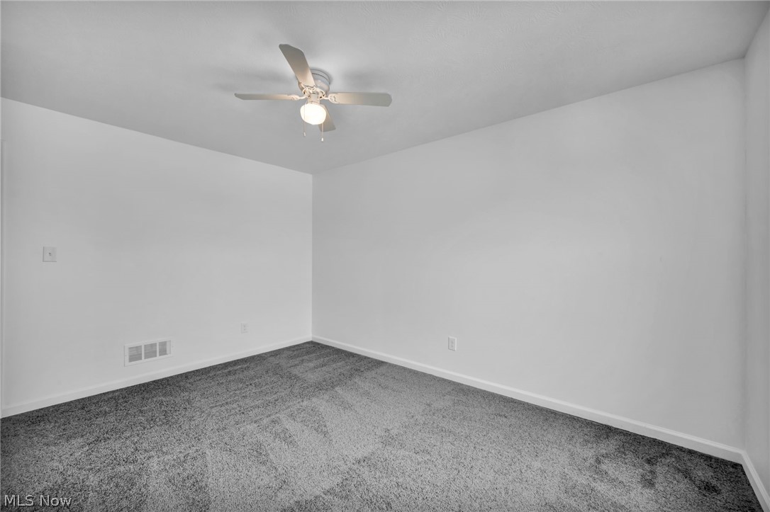 3670 Pennington Road Cleveland, OH 44120 - Photo 21 of 28 Carpeted spare room with baseboards and a ceiling fan