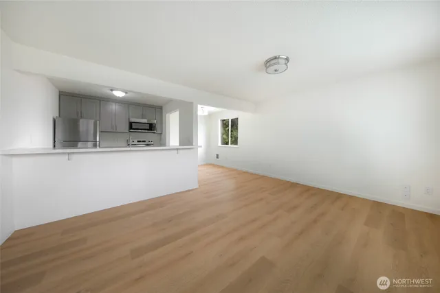 a view of a kitchen with a sink and a refrigerator